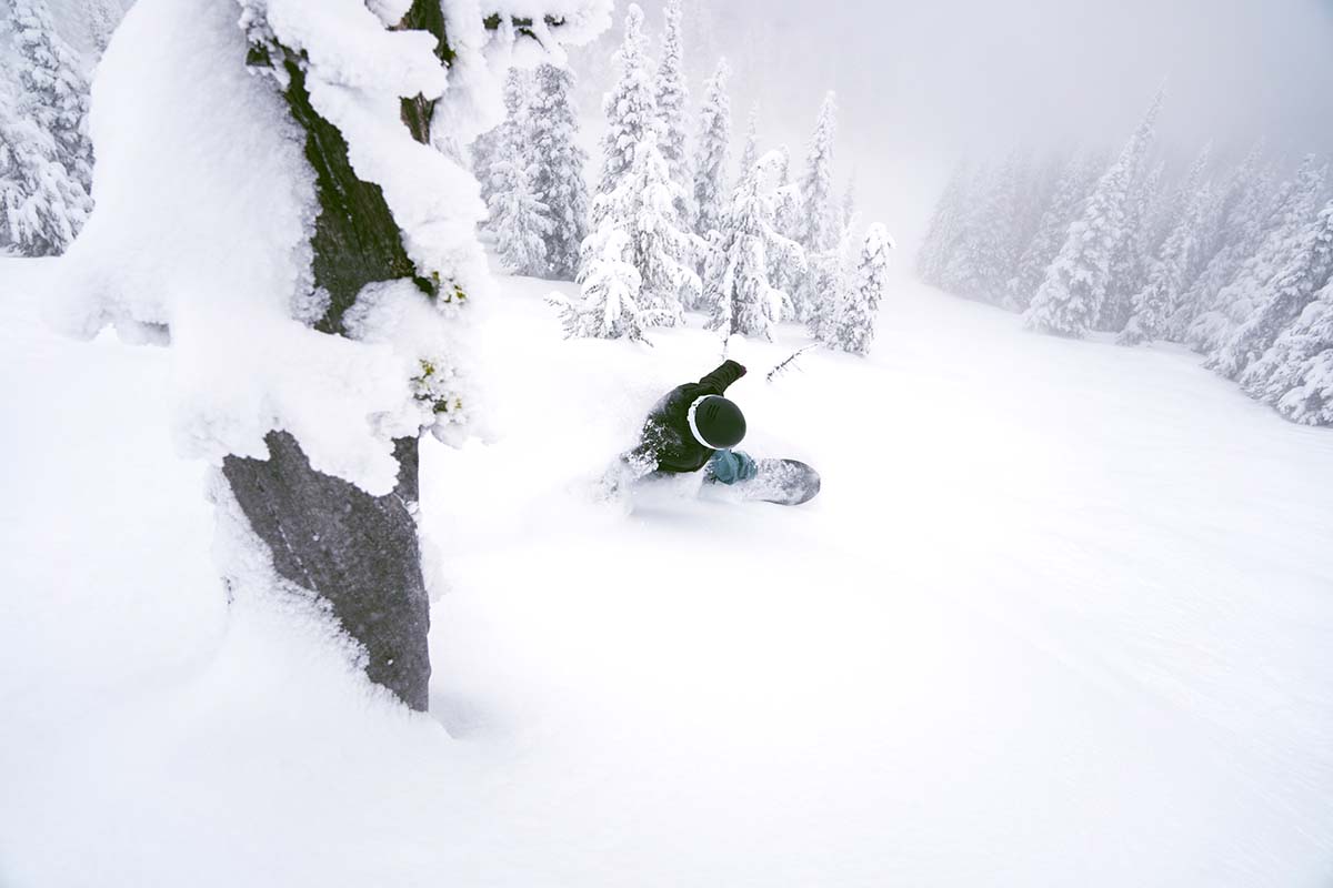 Snowboaring with hand in powder